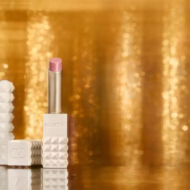 SPIKE VALENTINO IVORY vor einem Hintergrund aus schimmerndem Gold